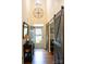 Inviting foyer featuring hardwood floors, stylish barn doors, and a decorative wall mirror at 9805 Coatbridge Dr, Charlotte, NC 28269