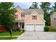Charming two-story home featuring a manicured lawn, two-car garage, and inviting front porch with tasteful landscaping at 9805 Coatbridge Dr, Charlotte, NC 28269
