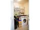 Compact laundry room with washer, dryer, storage shelves and organized supplies at 9805 Coatbridge Dr, Charlotte, NC 28269