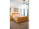 Spacious main bedroom has a ceiling fan, natural light and a wooden bedframe to inspire relaxation at 9805 Coatbridge Dr, Charlotte, NC 28269