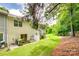Rear view of attached townhomes with backyard, patio, and green space at 1003 Silver Spring Rd, Fort Mill, SC 29715