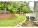 Landscaped backyard with green grass, trees, and a privacy fence providing a serene outdoor space at 1003 Silver Spring Rd, Fort Mill, SC 29715