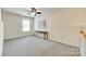 Spacious bonus room with neutral carpet, ceiling fan, and natural light at 1003 Silver Spring Rd, Fort Mill, SC 29715