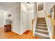 Inviting entryway with hardwood floors, staircase, and coat closet for convenient storage at 1003 Silver Spring Rd, Fort Mill, SC 29715