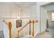 Upstairs hallway with wood railing leading to bedrooms at 1003 Silver Spring Rd, Fort Mill, SC 29715