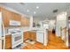 Functional kitchen with appliances, wood cabinetry, and an open view into the adjacent living spaces at 1003 Silver Spring Rd, Fort Mill, SC 29715