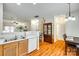 Open-concept kitchen featuring wood cabinets, a bar top, and views into the dining and living areas at 1003 Silver Spring Rd, Fort Mill, SC 29715