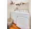 Bright laundry room featuring a white washer and dryer and overhead shelving for easy storage solutions at 1003 Silver Spring Rd, Fort Mill, SC 29715