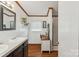 Bathroom boasts dual sinks, wood trim, and ample natural light, creating a relaxing atmosphere at 1007 W Cabaniss Rd, Shelby, NC 28150