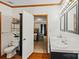 Bathroom leads to bedroom, showcasing vanity with dual sinks, toilet, and coordinated decor at 1007 W Cabaniss Rd, Shelby, NC 28150