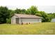 Spacious detached garage with a metal roof, concrete block construction, and a roll-up door at 1007 W Cabaniss Rd, Shelby, NC 28150