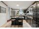 Modern kitchen with stainless steel appliances, a breakfast bar, and dark cabinetry at 1007 W Cabaniss Rd, Shelby, NC 28150