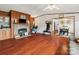Spacious living room featuring wood paneling, a stone fireplace, and hardwood flooring at 1007 W Cabaniss Rd, Shelby, NC 28150