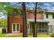 Backyard view featuring mature trees and lush landscaping with a partially obscured back of the home at 1035 Wexford Nw Pl, Concord, NC 28027