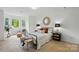 Bright bedroom with a comfortable bed, bay window, and stylish seating area at 1035 Wexford Nw Pl, Concord, NC 28027
