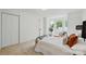Well-lit bedroom featuring a bay window, spacious closet, and minimalist decor at 1035 Wexford Nw Pl, Concord, NC 28027