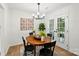 Dining room with a wooden table, black chairs, and glass door access to the backyard at 1035 Wexford Nw Pl, Concord, NC 28027