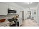 Modern kitchen featuring sleek white cabinets and stainless steel appliances at 1035 Wexford Nw Pl, Concord, NC 28027