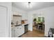 Open kitchen featuring white cabinets and a view of the adjacent dining room at 1035 Wexford Nw Pl, Concord, NC 28027