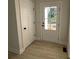 Inviting entryway with new flooring, closet, exterior door with glass panels, and natural light at 120 Autumn Blaze Rd, China Grove, NC 28023
