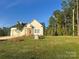 Charming two-story home with manicured lawn, mature trees, and a stone accent in a desirable neighborhood at 120 Autumn Blaze Rd, China Grove, NC 28023
