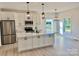 Modern kitchen featuring white cabinets, stainless steel appliances, a center island with quartz countertops, and pendant lighting at 120 Autumn Blaze Rd, China Grove, NC 28023
