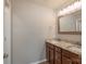 Double vanity with granite countertops, wooden cabinets, framed mirror, and tile flooring at 1211 Gold Rush Ct, Fort Mill, SC 29708