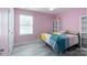 Pink bedroom featuring a stylish bed, a window and light colored wood-look flooring at 1211 Gold Rush Ct, Fort Mill, SC 29708