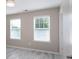 Bright bedroom with light gray walls, two windows and light-colored wood-look flooring at 1211 Gold Rush Ct, Fort Mill, SC 29708