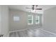 A light filled bedroom with light gray walls, a ceiling fan and three windows at 1211 Gold Rush Ct, Fort Mill, SC 29708