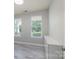 Bright bedroom with two windows, neutral paint, and stylish plank flooring at 1211 Gold Rush Ct, Fort Mill, SC 29708