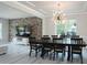 Stylish dining room featuring statement lighting, gray plank flooring, and a decorative brick accent wall at 1211 Gold Rush Ct, Fort Mill, SC 29708
