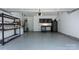 Spacious two car garage with painted floor, overhead door, shelving, storage cabinets and workbench at 1211 Gold Rush Ct, Fort Mill, SC 29708