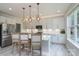 Bright kitchen features an island with counter seating, stainless steel appliances, and modern pendant lighting at 1211 Gold Rush Ct, Fort Mill, SC 29708