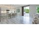 Modern kitchen with white cabinets, counter seating, and sliding doors for outdoor living at 1211 Gold Rush Ct, Fort Mill, SC 29708