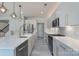 Open kitchen features an island with sink, stainless steel appliances, and modern white cabinetry at 1211 Gold Rush Ct, Fort Mill, SC 29708