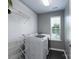 Well-lit laundry room featuring modern appliances, shelving, and a drying rack near a window at 1211 Gold Rush Ct, Fort Mill, SC 29708