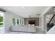 Bright living room with hardwood floors, brick accent wall, and large windows at 1211 Gold Rush Ct, Fort Mill, SC 29708