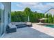A view of the travertine patio with furniture and landscaping at 1211 Gold Rush Ct, Fort Mill, SC 29708