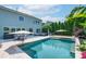 A view of the in-ground pool, travertine patio, and the home's exterior at 1211 Gold Rush Ct, Fort Mill, SC 29708