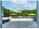 Backyard view of the in-ground pool, travertine patio, and manicured landscaping at 1211 Gold Rush Ct, Fort Mill, SC 29708