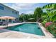 A view of the in-ground pool, travertine patio, and the home's exterior at 1211 Gold Rush Ct, Fort Mill, SC 29708