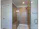 Luxurious tiled shower with built-in bench and glass enclosure in a modern bathroom at 1211 Gold Rush Ct, Fort Mill, SC 29708