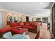 Large living room with a red patterned sectional couch, mirrors, and pool table in background at 1220 Broadside Rd, York, SC 29745
