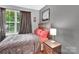 This bedroom features a window, bed, poster, blinds, side table, and dark curtains at 125 Lynch Cir, Mooresville, NC 28117