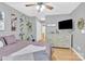 Bedroom featuring a ceiling fan, window, plants, and a dresser with a TV on top at 125 Lynch Cir, Mooresville, NC 28117