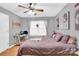 Bedroom featuring a ceiling fan, window, decor, a door, and a lavender bed at 125 Lynch Cir, Mooresville, NC 28117