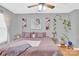 Bedroom featuring a ceiling fan, windows, and a lavender bed, plants, and decor at 125 Lynch Cir, Mooresville, NC 28117