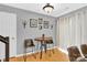 This dining area has a round wood table, brown chairs, wood floors, and white curtains, with decor on the gray walls at 125 Lynch Cir, Mooresville, NC 28117