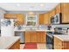 Well-lit kitchen with oak cabinets, updated appliances, and ample counter space for cooking at 125 Lynch Cir, Mooresville, NC 28117